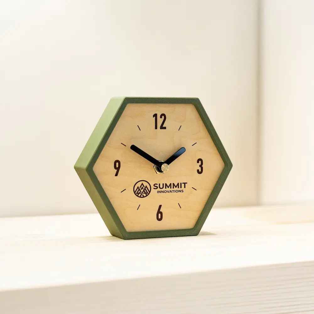 Hexagon wooden desk clock with green frame and engraved logo